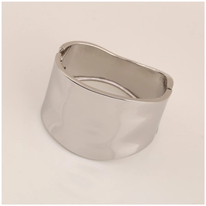 Detailed view of silver irregular wavy cuff bracelet with polished finish and hinge