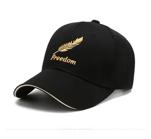 Detail of gold feather embroidery and Freedom text on black mesh baseball cap