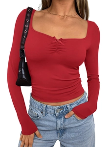 Close-up of red slim fit U-neck long sleeve top with decorative bow detail and cropped hem
