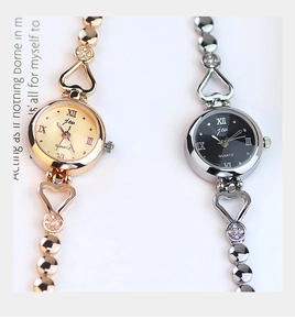 Detail of quartz watch with heart-shaped bracelet links and Roman numeral dial