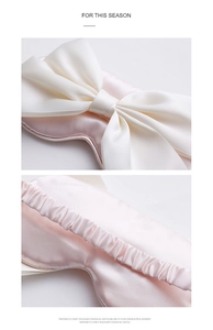 Detail of pink silk sleep mask showing the large white bow and pleated elastic strap