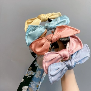 Detail of silk satin headband collection with floral patterns and five macaron colors