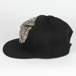 Detail of silver metal cross rivets and rhinestones on black hip hop baseball cap