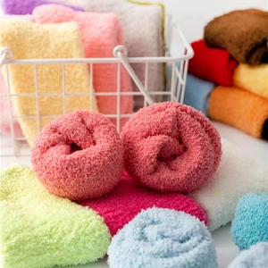 Soft coral fleece winter mid-calf socks in various colors displayed in a white wire basket