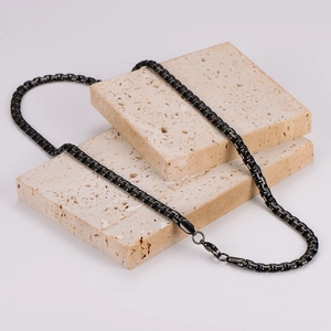 Minimalist black stainless steel square link chain necklace for men on stone display