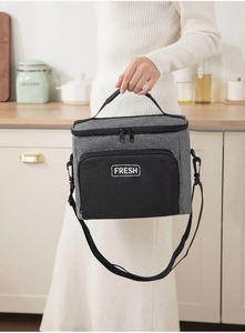 Close-up of insulated lunch bag with thick grey oxford fabric and detachable shoulder strap