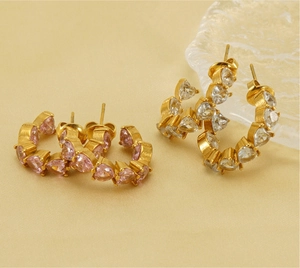 Macro view of C-shaped U-style earrings with pink and white heart zircons