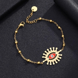 Detailed macro view of gold plated stainless steel evil eye bracelet with enamel finish