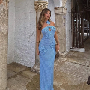 Detail of light blue crochet halter dress with 3D floral accents and knit texture