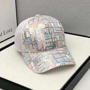 Macro shot of colorful sequin patterns and breathable mesh fabric on baseball cap