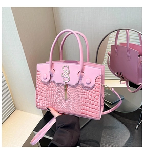 Pink retro crossbody bag detail featuring crocodile pattern leather and tassel charm