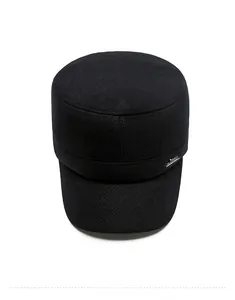 Top view of men's winter flat top cap in black fabric with a silver metal logo detail