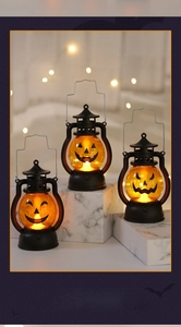 Close-up of three Halloween LED pumpkin lanterns with different spooky face patterns
