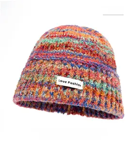 Detail of colorful knitted bucket hat texture and Love Fashion textile label