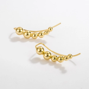 Detailed view of 925 sterling silver golden curved bead earrings on a white background