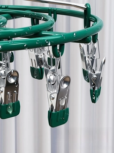 Macro detail of waterproof green aluminum alloy sock rack with non-slip clothes clips