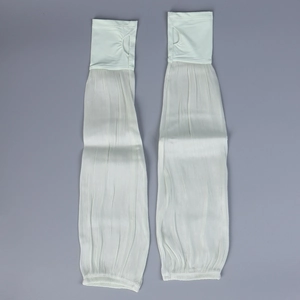 Close-up of white sun protection sleeves featuring pleated fabric and thumb hole design