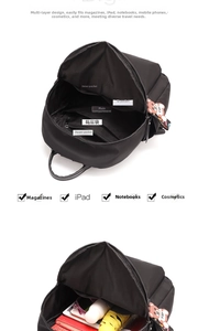 Detailed interior view of black nylon backpack with multi-layer storage compartments