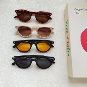Retro oval cat-eye sunglasses set in leopard, beige, and black frames with UV protection