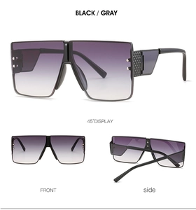 Detail view of square rimless sunglasses with metal rivets and textured temples