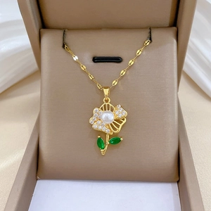 Detail of flower necklace with pearl center, cubic zirconia petals and green leaves