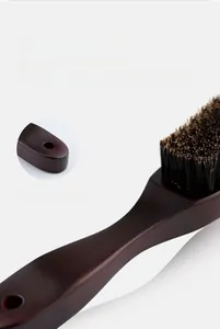 Detail view of solid lotus wood long handle brush with hanging hole and dense bristles