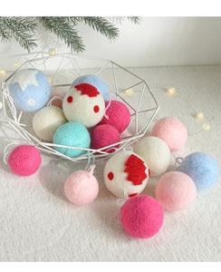 Close-up of colorful wool felt Christmas balls with star patterns in a metal basket