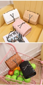 Detailed display of five color options for the quilted crossbody bag with metal V logo