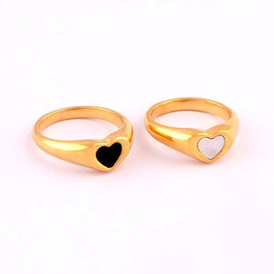 Macro shot of black and white epoxy heart charms on 18K gold-plated stainless steel rings