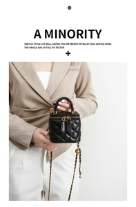 Detail of a mini quilted black chain bag showing matte leather texture and gold hardware