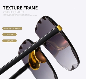 Detail view of durable metal alloy hinges and golden nose pads on rimless sunglasses