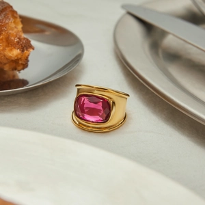 Detailed close-up of 18K gold-plated ring with a large rectangular pink zircon stone