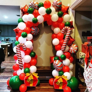 Detail showing a Christmas balloon arch with candy canes and gift box balloons decor