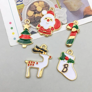 Detailed flat lay of Christmas alloy enamel charms featuring Santa, tree, and deer