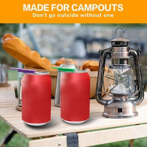 Outdoor camping scene showing purple and green easy can openers on soda cans on wood table