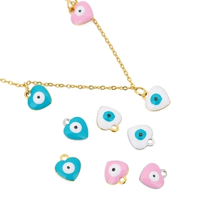 Macro shot of colorful enamel heart evil eye pendants in blue, pink, and white tones