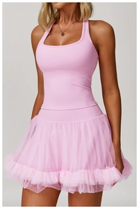 Detail view of the pink pleated tiered mesh layers and elastic edge on the sports skirt
