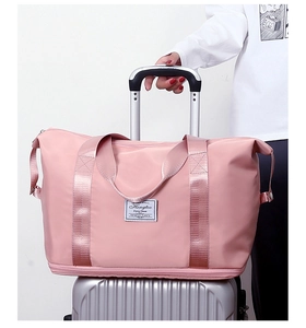 Pink travel bag with integrated luggage sleeve attachment for convenient suitcase carry