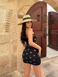 Sexy black two-piece set with white bow print featuring tube top and mini skirt outfit