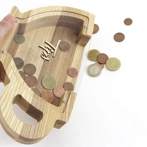 Detailed close-up of a wooden oak tip jar with coins and transparent glass front panel
