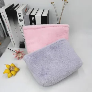 Detail of plush macaron colored storage pouches in soft pink and purple faux fur