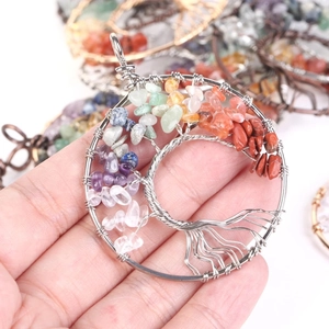 Detailed view of handmade Tree of Life wire wrapped pendant with multi-color natural crystals