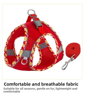 Detail of red breathable mesh pet harness with reflective strips and plaid webbing trim