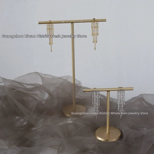 Close-up of elegant gold chain fringe earrings and silver crystal tassel studs set