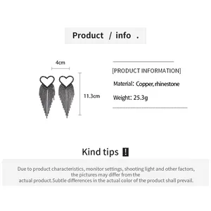 Detailed size view showing 11.3cm length of hollow heart tassel earrings with rhinestones
