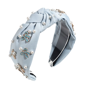 Light blue knotted headband with imitation pearls and gold-rimmed enamel bows