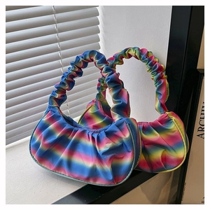 Close-up of vibrant pleated rainbow gradient shoulder bags with sleek satin finish