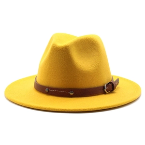 Detail of a bright yellow fedora hat with a brown leather band and metal buckle accent