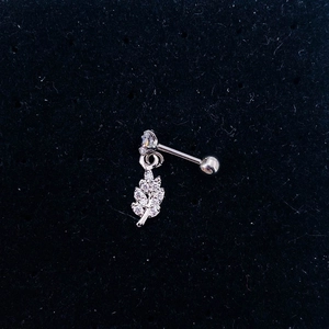 Detailed view of silver leaf-shaped labret stud earring with inlaid sparkling zircons