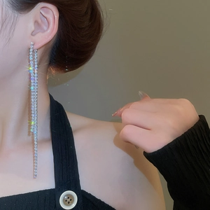 Detailed view of silver zircon tassel earrings on model showing length and drape